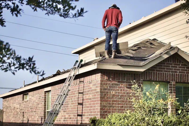 Professional roofer working on a residential roof in Foothill Farms